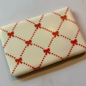 Preppy Bows Cookie Stencil, airbrushed in red on a sugar cookie.