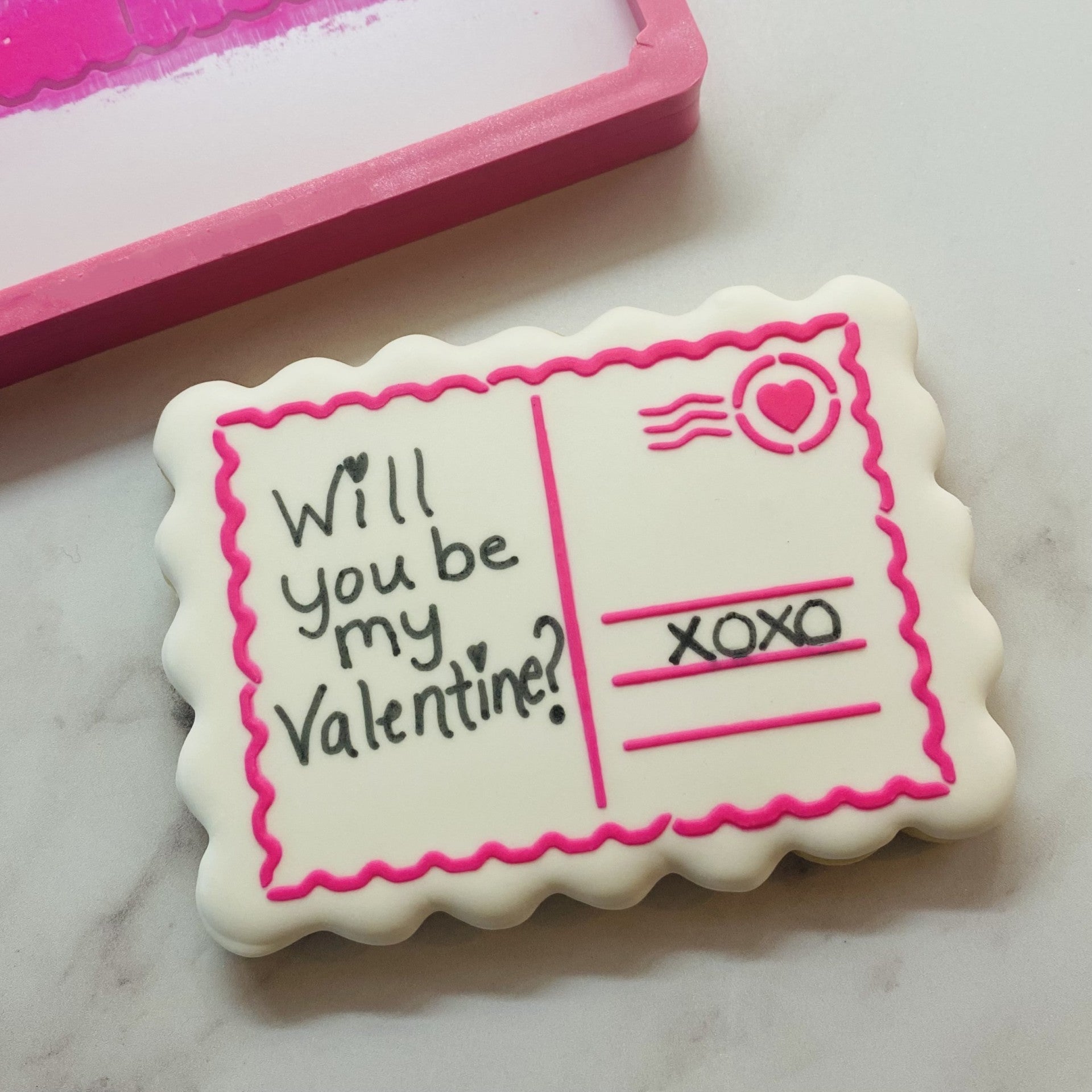 Sending My Love stenciled cookie decorated with black edible marker.