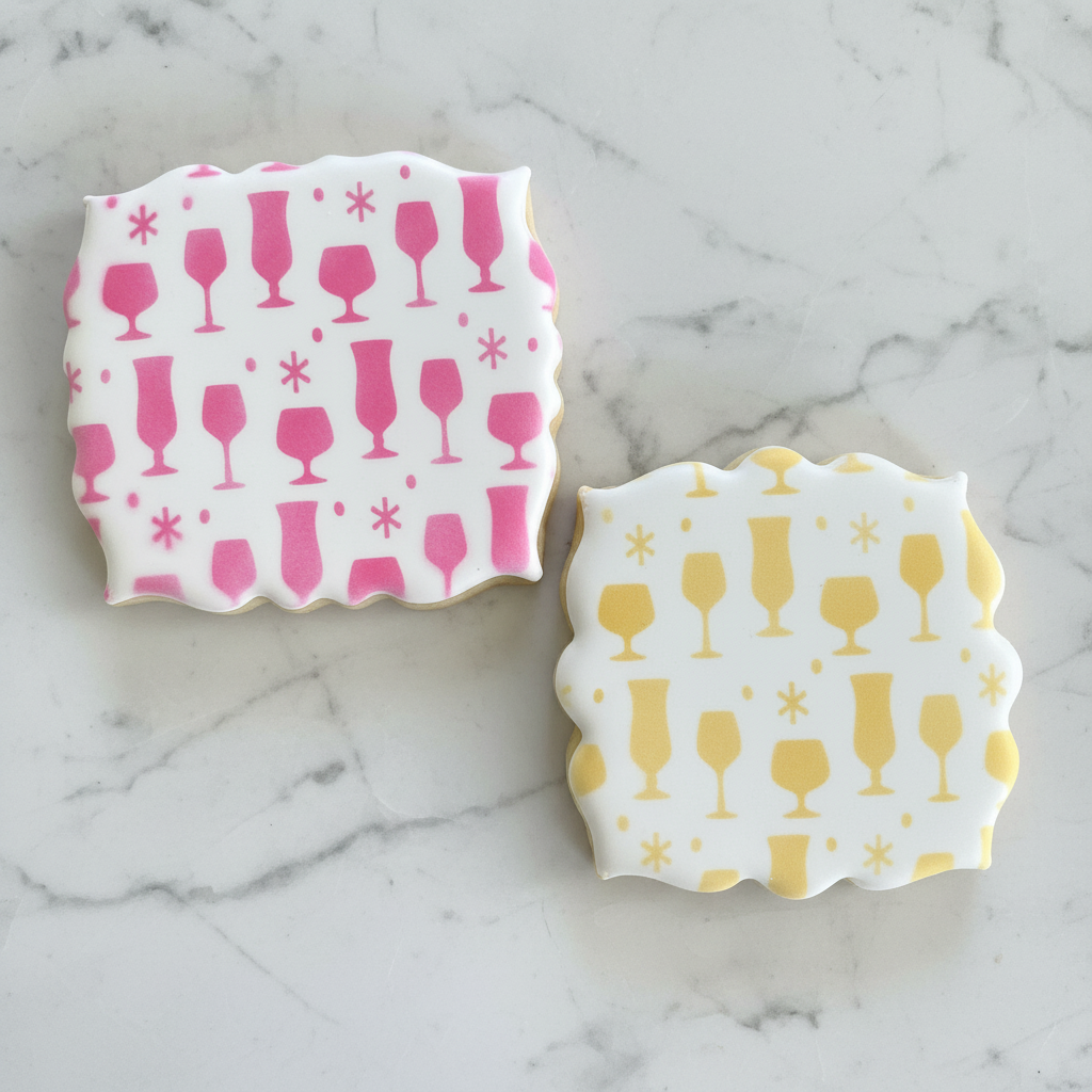 Two plaque shaped cookies decorated with our Bar Glasses Cookie Stencil in pink and yellow