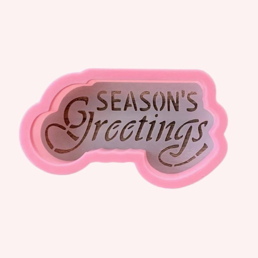 Scrolly Seasons Greetings Cookie Stencil and Cutter, a 2-piece set for decorating holiday cookies.